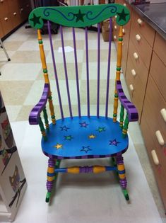 a purple and blue rocking chair in a kitchen