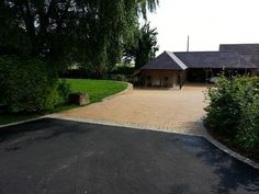 a driveway leading to a large house