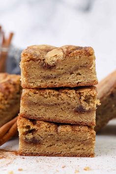 cinnamon sugar bars stacked on top of each other with cinnamon sticks in front of them