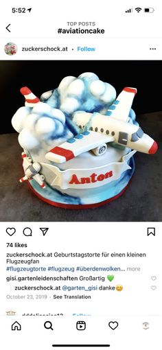 an airplane cake on top of a plate with the word anton written in german