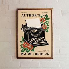 an old - fashioned typewriter is mounted on the wall next to a sign that says author's day