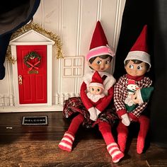 two elf dolls sitting next to each other