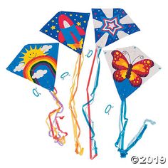 three colorful kites flying in the sky with stars and sun designs on each one