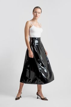 Stun in this black glossy wet look circular skirt! Featuring a sleek faux leather finish and latex feel, this midi skirt adds bold edge to any outfit. Perfect for women's night-out looks, statement fashion, or pairing with a suit. Ideal for stylish, confident women seeking bold, on-trend clothing. Edgy Skirt, Circular Skirt, Confident Women, Statement Fashion, Leather Finish, Wet Look, Confident Woman, Faux Leather Skirt, Style Expert