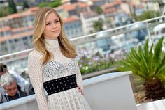 a woman standing in front of a crowd at the venice film festival on may 22, 2013