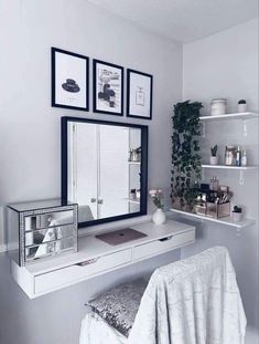 a mirror and some shelves with pictures on it in a room that has white walls