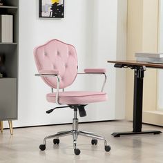 a pink office chair sitting in front of a desk with bookshelf behind it