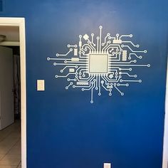 a blue wall with a circuit board design painted on it