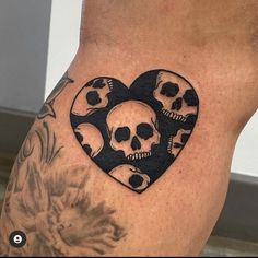 a woman's thigh with skulls in the shape of a heart