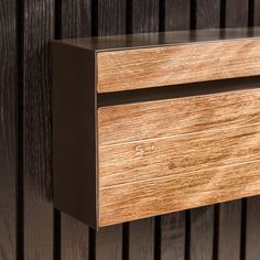 a close up of a wooden drawer on a wall