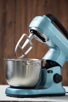 a blue mixer sitting on top of a counter