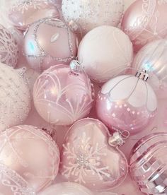 pink and white christmas ornaments in a pile