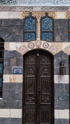 an ornately decorated building with two wooden doors