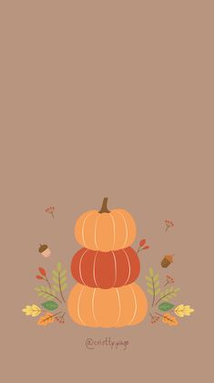 a stack of pumpkins sitting on top of each other in front of a brown background