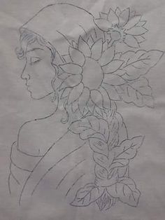 a drawing of a woman with flowers in her hair on a piece of white paper