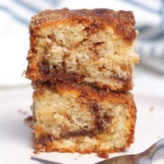 two pieces of cake sitting on top of a white plate next to a silver fork