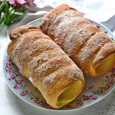 two pastries on a plate with the words domaci trdelnik starcesky