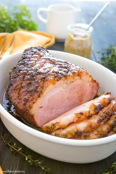 a close up of a meat in a bowl with text overlay that reads easy maple dijon gaged ham