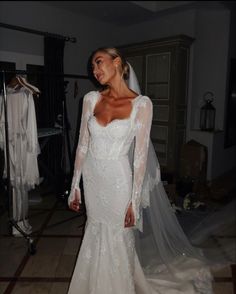 a woman in a white wedding dress and veil