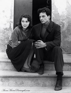 black and white photograph of man and woman sitting on steps