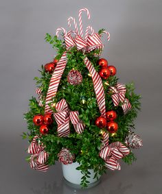 a potted christmas tree with candy canes and ornaments