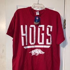 University Of Arkansas Razorbacks All-Out Hogs Jumbo Logo Shirt Smoke Free Closet Size: Large. Color: Red. 100% Cotton. Approximate Measurements While Laying Flat. Armpit To Armpit: 21” Shoulder To Bottom Hem(Length): 29” If You “Like” An Item, Try Making An Offer. Please Let Me Know If You Have Any Questions. Thanks For Checking Out My Closet! Tags Go Hogs Go University Of Arkansas Ncaa College Football Athletics Uark Razorback Stadium Wps Wooo Pig Sooie Sec Southeastern Conference Natural Stat Collegiate Red Summer Tops, Red Cotton Shirt For Game Day, School Spirit Red Shirt With Graphic Print, Red Casual Shirt For Game Day, Casual Red Shirt For Game Day, Red Cotton Top For Game Day, Red Graphic Print Shirt For College, Red Cotton Shirt For School Spirit, Red Cotton Fan Apparel Shirt