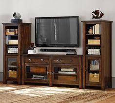 an entertainment center with bookshelves and a flat screen tv