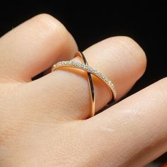 a woman's hand with a gold ring on it and diamond band in the middle