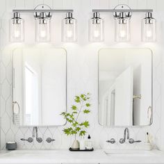 a bathroom with two sinks and three lights on the wall above them is shown in this image