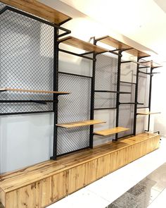 the shelves are made out of wood and metal with wire mesh on them, along with shelving