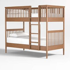 a wooden bunk bed with white sheets and pillows on it's bottom level, against a gray background