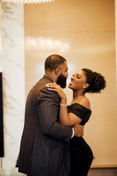 a man and woman dance together in an elegant room