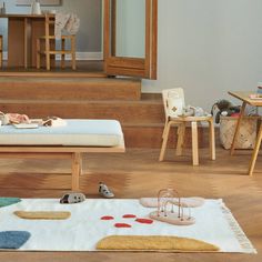 a child's room with wooden stairs and furniture