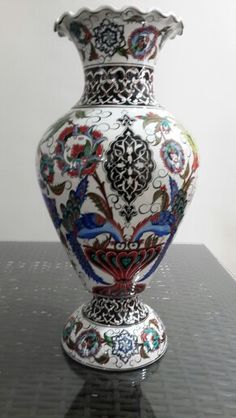 an ornate vase sitting on top of a table