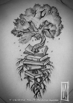 the back of a woman's neck with a tree and books tattoo on it