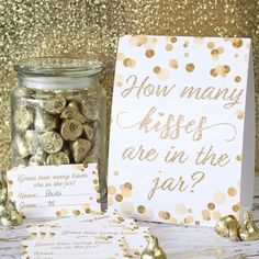 some gold confetti is in a jar and there are cards on the table