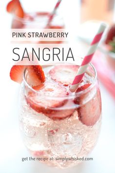 pink strawberry sangria in a glass with strawberries on the rim and text overlay that reads, pink strawberry sangria