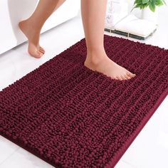 a person standing on top of a bathroom rug