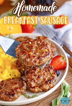 some hamburger patties are on a plate with eggs and fruit in the background that says homemade breakfast sausage