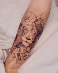 a woman's leg with a lion and flowers on it