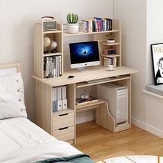 a bedroom with a bed, desk and bookshelf next to a computer monitor