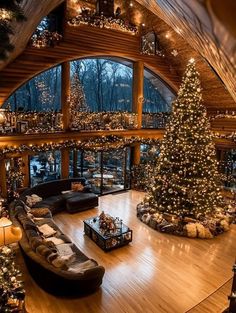 a large living room with a christmas tree in the center and lots of lights on the ceiling