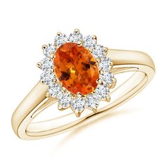 an orange and white diamond ring set in yellow gold