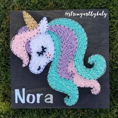 a string art unicorn is on the grass