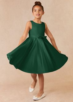 Complete your bridal party with our clean modern Matte Satin flower girl dress, Coco. Her scoop neckline is complimented by a belt with a bow at the front. The skirt is pleated beautifully to flare as she walks down the aisle. This dress is not only perfect for a flower girl at a wedding but also versatile enough for other special occasions. Emerald Green Dress For A Wedding Bridesmaid For Kids, Flower Girl Dresses Emerald Green, Flower Girl Dresses Green, Emerald Wedding Flower Girl, Emerald Green Flower Girl Dress, Flower Girls Dresses Dark Green, Flower Girl Gown Green, Green Flower Girl Dresses, Amber Wedding