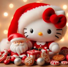 a hello kitty figurine sitting next to santa clause