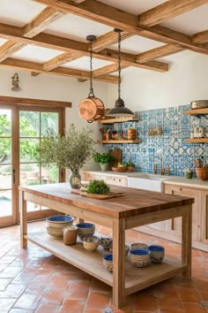 Sun-drenched Mediterranean kitchen with terracotta floors azure backsplash wooden beams and central island with butcher block top Blue Kitchen Mediterranean, Spanish Modern Kitchen Backsplash, Tiles Island Kitchen, New Mexico Kitchen Design, Italian Villa Aesthetic Kitchen, Arizona Kitchen Ideas, Spanish Themed Kitchen, Portuguese Homes Interiors, Spanish Cottage Kitchen