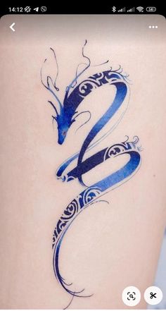 a woman's lower back tattoo with a blue snake design on her left side