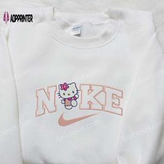 Nike x Hello Kitty Embroidered Shirt: Introducing the perfect fusion of sporty style and iconic cuteness! This Nike x Hello Women Nike Sweatshirt, Nike Hello Kitty Sweater, Hello Kitty Nike Sweatshirt, Fall Graphic Sweatshirt, Cute Nike Hoodies, Hello Kitty T-shirt, Hello Kitty Shirt Outfits, Hello Kitty Items Shops, Hello Kitty Inspired Outfits