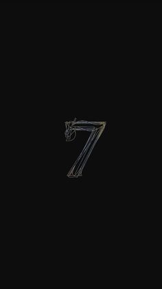 the number seven is made up of metal bars on a black background with an arrow pointing to it